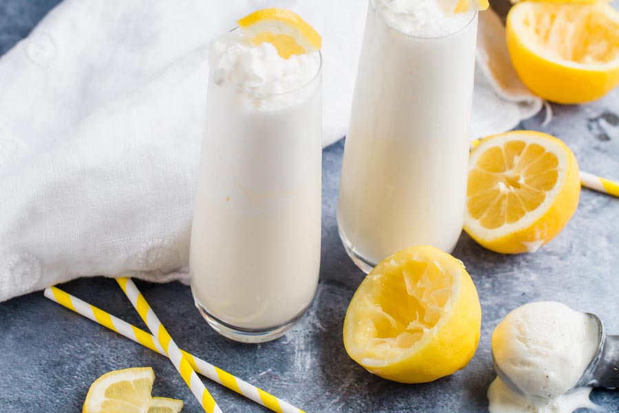 summertime frozen keto milkshake with yellow straws and whipped cream