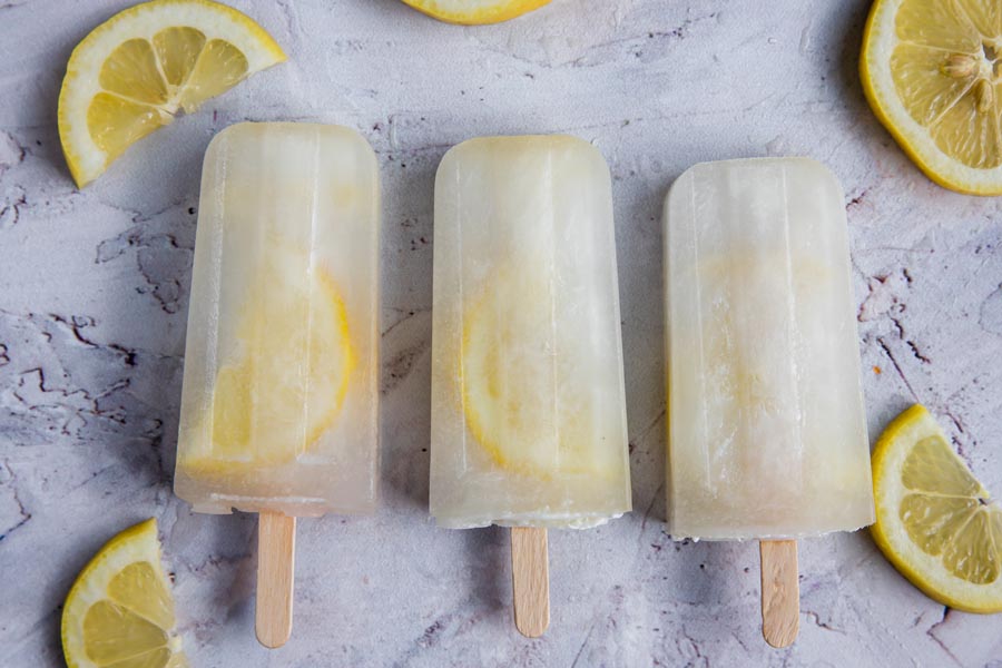 three keto popsicles in a row with lemon slices