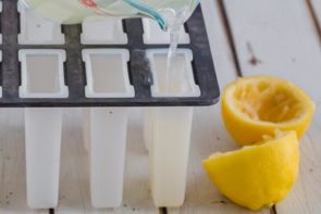 pouring lemonade into a popsicle mold