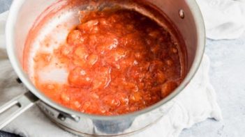 strawberries and their juices in a saucepan