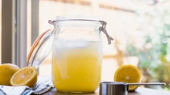 fresh lemonade in a mason jar next to a window