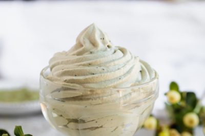 creamy swirled matcha cream in a small bowl with white berries next to it