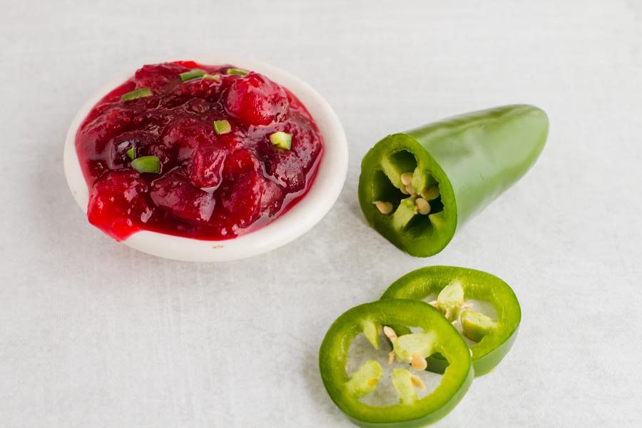 cranberry sauce in a dish next to jalapenos