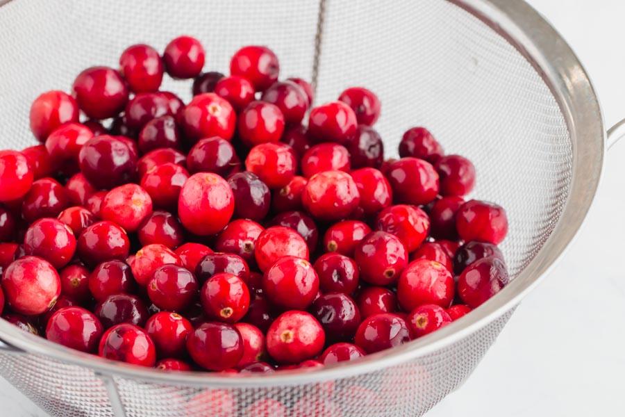 a colander full of cranberries