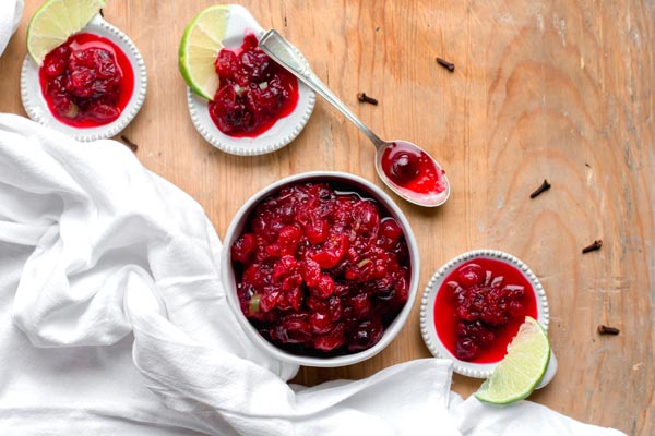 keto jalapeno cranberry sauce in bowls with cloves around
