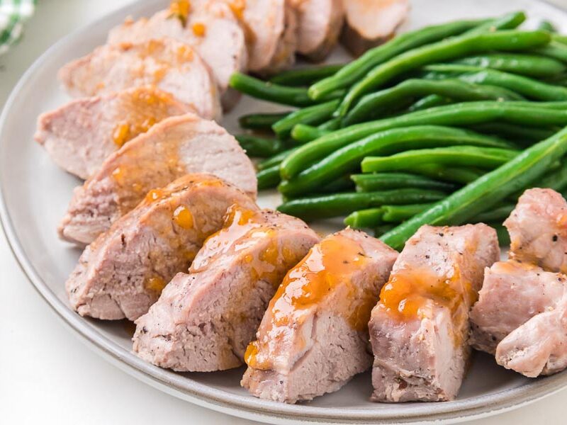 Sliced pork tenderloin topped with citrus glaze and served with fresh green beans.