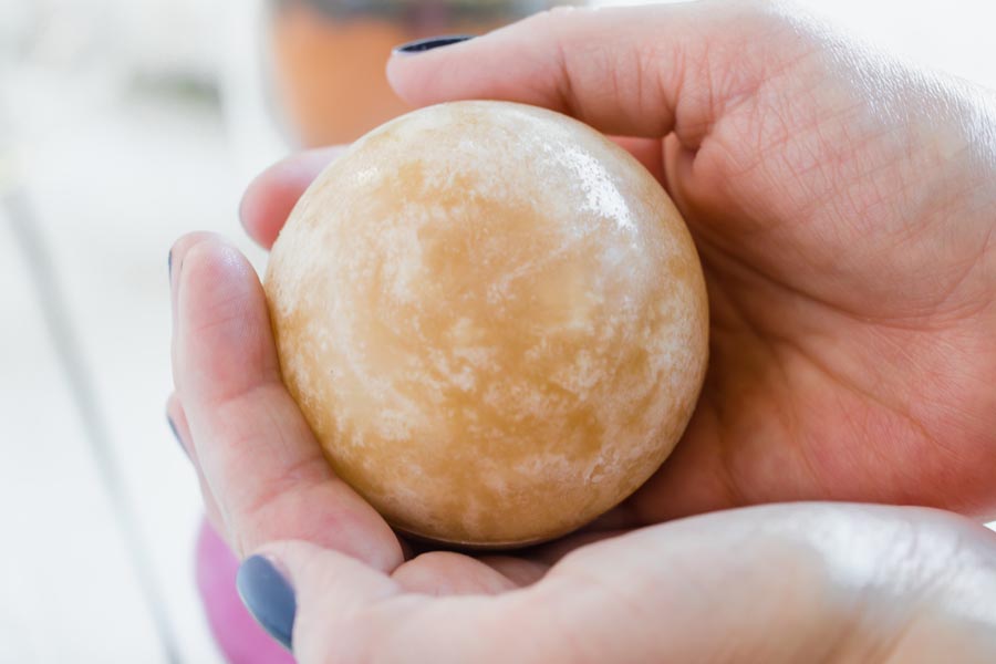 holding a white tea bomb in hands