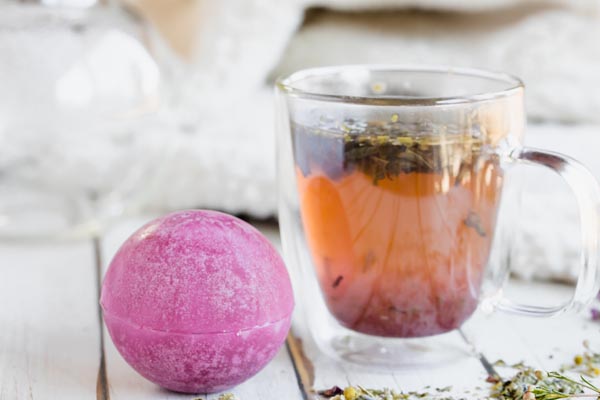 a mug of tea next to a tea bomb