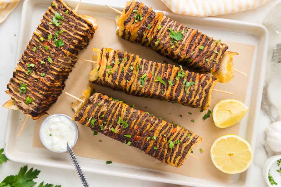 Low carb tortilla kebabs served on skewers with lemon wedges and a side of creamy dipping sauce.