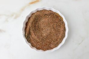Low carb tortilla kebab base pressed into a round baking dish before assembling the skewers.