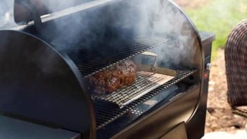 meatloaf smoking in a pellet grill on a grill tray