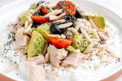 Tuna and cottage cheese bowl with avocado, cherry tomatoes, olives, almonds and chia seeds.