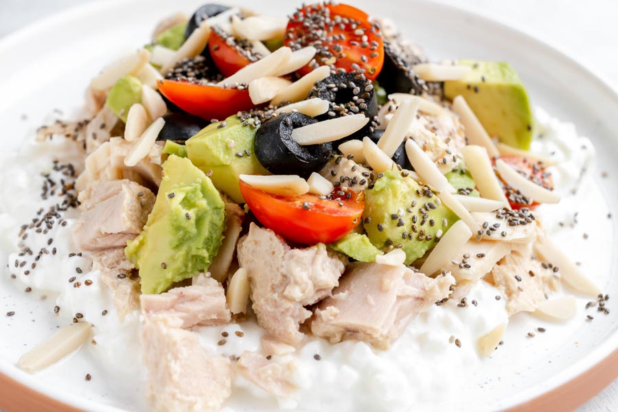 Tuna and cottage cheese bowl with avocado, cherry tomatoes, olives, almonds and chia seeds.