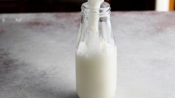 pouring a milkshake into a milk jar