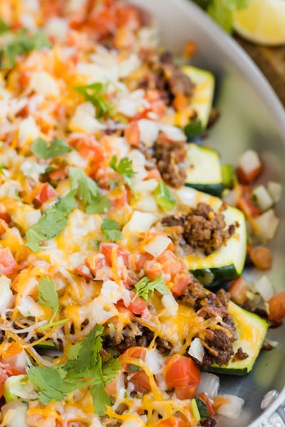 Zucchini taco boats filled with seasoned ground beef, melted cheese and salsa.